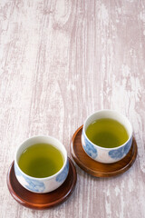 木製コースターにのった緑茶の背景素材