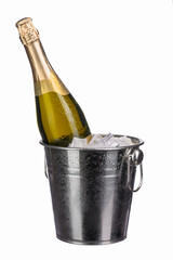 a bottle of chilled sparkling champagne with water drops in an ice bucket on a white isolated background