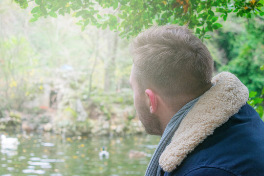 Close Portrait Of Young Man From Behind In A Park