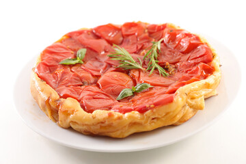 tomato quiche and herbs on white background