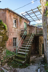 View of empty stone streets of an abandoned mountain village with a few remaining residents