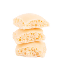 Tasty porous chocolate, isolated on white background. White aerated chocolate.