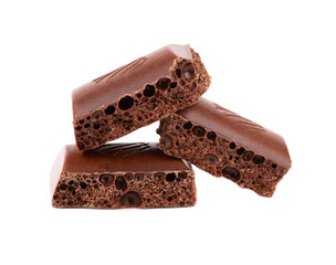 Porous chocolate pieces isolated on white background. Black aerated chocolate.