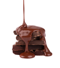 Chocolate pieces stack and chocolate syrup isolated on white background. Close up.