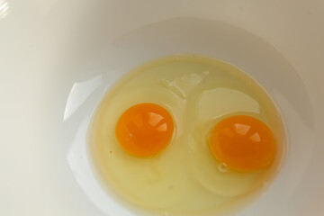 Raw eggs in a bowl for making an omelet or dough, top view