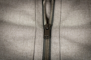 Metal zipper on the sports jacket. Close up. Selective focus.