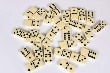 A game of dominoes on a light background. Close-up. Selective focus.