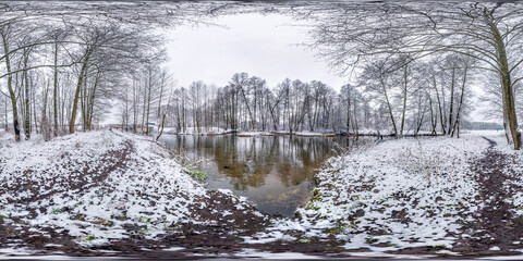 Winter full spherical seamless hdri panorama 360 degrees angle view on road in a snowy park near...