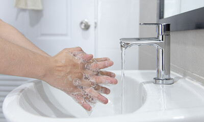 Men are washing their hands in the sinks to clear respiratory bacteria and viruses, sanitation and reduce the spread of COVID-19 that is spread around the world, Hygiene ,Sanitation concept.