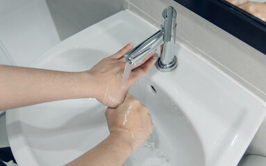 Men are washing their hands in the sinks to clear respiratory bacteria and viruses, sanitation and reduce the spread of COVID-19 that is spread around the world, Hygiene ,Sanitation concept.