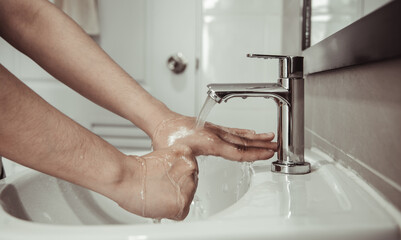 Men are washing their hands in the sinks to clear respiratory bacteria and viruses, sanitation and reduce the spread of COVID-19 that is spread around the world, Hygiene ,Sanitation concept.