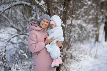 Fototapeta na wymiar A woman with a baby on a walk in winter
