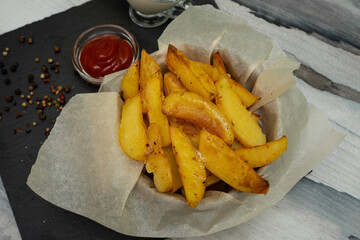 Golden baked new potatoes for dinner. Ketchup sauce and sour cream.