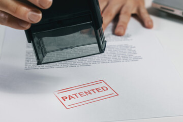 put a patented stamp on document. intellectual property protection - obrazy, fototapety, plakaty