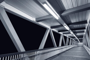 Empty modern foot bridge at night