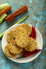 Plate of uncooked cutlets on a rustic kitchen table background
