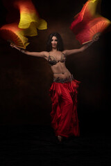Oriental dancer with a saber. Belly dance. The brunette. Red.