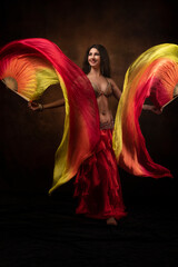 Oriental dancer with a saber. Belly dance. The brunette. Red.
