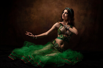 A young woman in an oriental suit. Scheherazade's fairy tale. The brunette. Green.