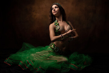 A young woman in an oriental suit. Scheherazade's fairy tale. The brunette. Green.