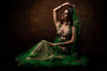 A young woman in an oriental suit. Scheherazade's fairy tale. The brunette. Green.