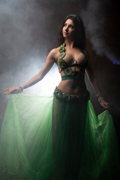 Oriental dancer. Belly dance. Smoke. Fairy tale. The brunette.