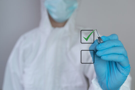 Coronavirus Vaccination Choice, Acceptance Of Vaccine Is It Good Or Bad To Be Vaccinated? Healthcare Worker Nurse, Doctor Dressed In A Medical Face Mask Protective Coverall Check Mark Covid-19 Concept