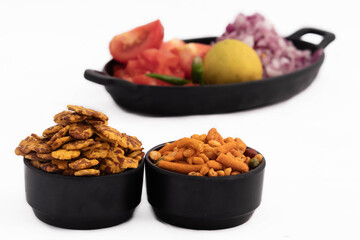 Famous Salted Snacks Of India Chatpata Namkeen Chana Jor Garam Daal Boot Smashed Chickpeas And Crispy Mixture Served With Chopped Masala Onions Lemon And Tomatoes On White Background For Custom Text