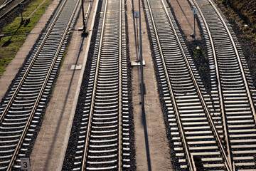 railway tracks under the bridge and go into the distance