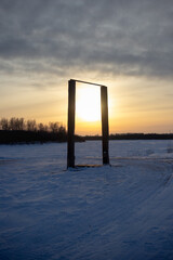 Horizontal bar in a snow field at sunset