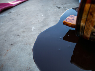 Spilled paint from the can on the cement floor