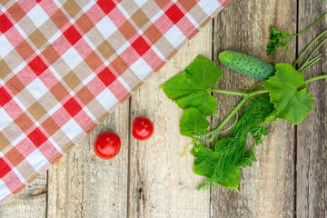 Fresh cucumber with leaves on a wooden table. The rural style. High quality photo