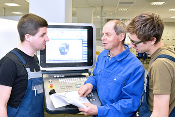 Group of young people in technical vocational training with teacher