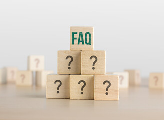 FAQ, Q and A or Problem solving concept. Wooden blocks with question mark icon arranged in pyramid...