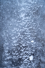 The icy texture on the frozen river. Crystal abstraction for the background. Macro ice surface shoot. 