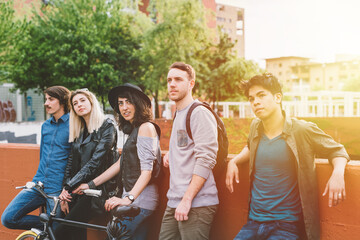 Group of multiethnic friends outdoor in the city looking away