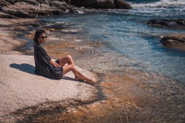 Young beautiful woman having fun in water at beach. Summer photo of young beautiful girl in sea swimming and having fun. Female on beach enjoying sea vacation traveling