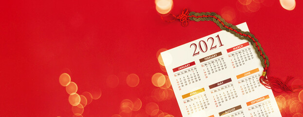 Chinese culture 2021 banner on a red background with a calendar and decoration