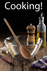 Cooking concept with utensils oil and spices in rustic kitchen interior