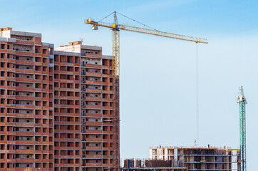 Construction, cranes. Tower cranes and modern buildings under construction