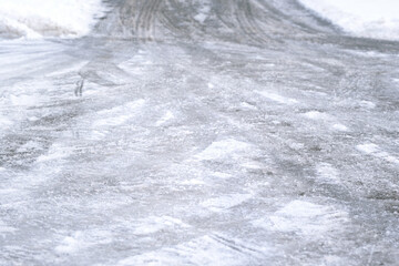 Background and detail of a smooth and icy road in winter