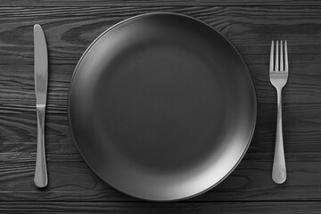 Minimalistic black background table setting in a restaurant. minimalism of table setting, top view