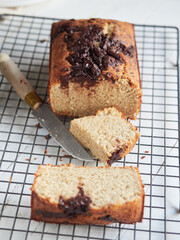 portion of banana bread with chocolate on topo on a cooling rack