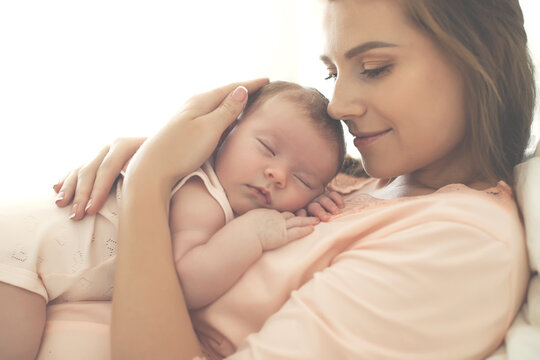 Portrait of a beautiful mother, with her nursing baby. High quality photo.