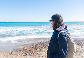 Girl with face mask at the beach