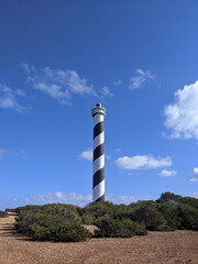 Ibiza, Islas Baleares, Spain  - January 16, 2021: Lighthouse sea rock landscape. Lighthouse scene. Lighthouse view. The Moscarter Lighthouse..