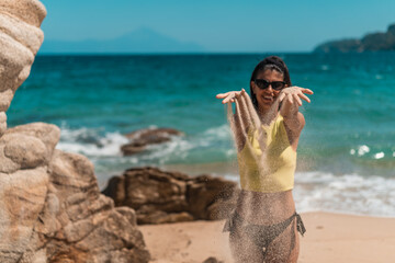 Young beautiful woman having fun at beach. Summer photo of young beautiful girl. Female on beach enjoying sea vacation traveling