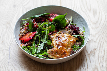 Healthy salad with glazed chicken tigh