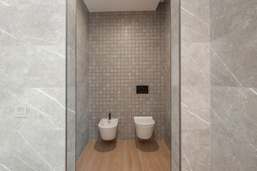 Fototapeta na wymiar Modern gray shower room. Shower room without tray. Walls tiled with natural material.