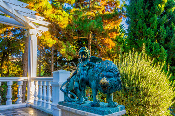 An old metal sculpture of a lion and a child.
